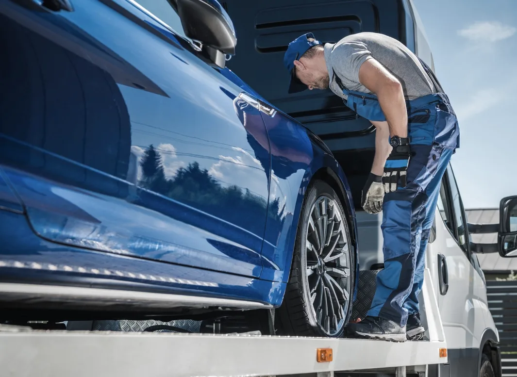 Maple tow truck operator loading vehicle